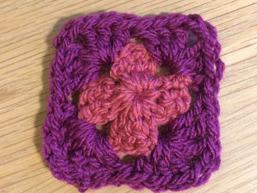 Round 2 of the Summer Fruits Granny Square with plum coloured yarn