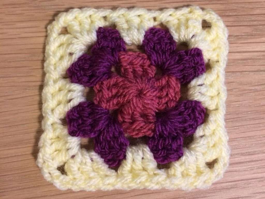 Round 3 of the Summer Fruits Granny Square with lemon coloured yarn