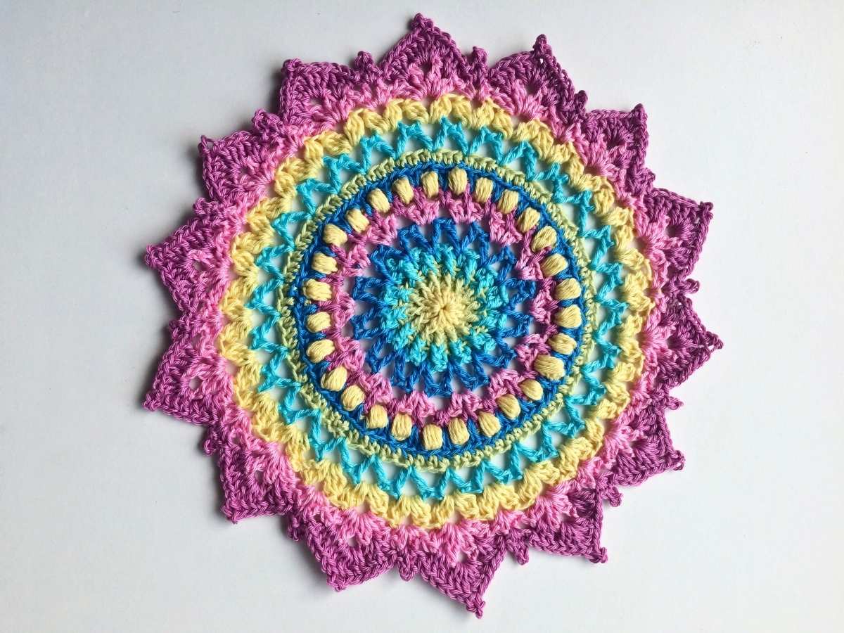 Crochet Mandala made with cotton yarn displayed on a white background