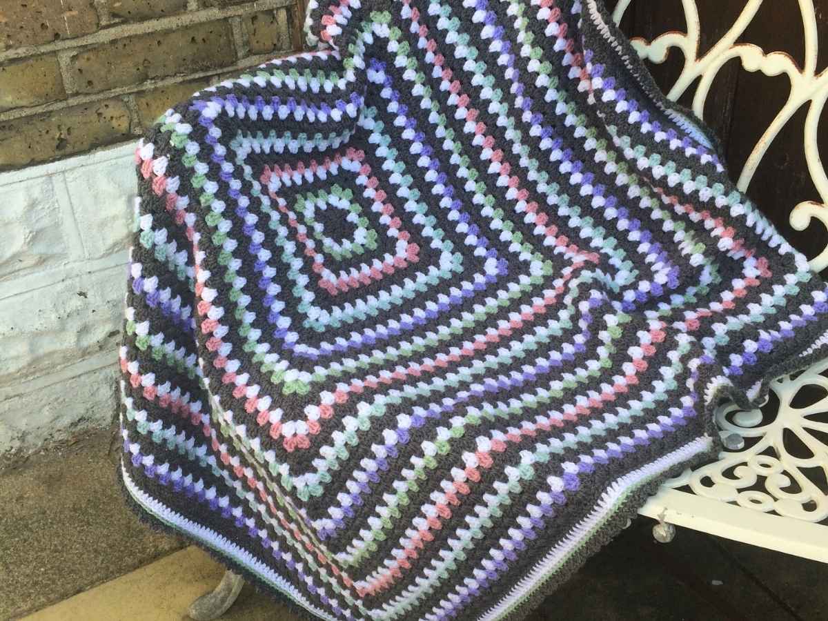 Graphite Granny Square finished and displayed on a bench