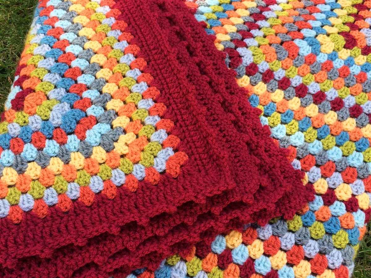 Folded crochet granny square blanket made in autumn colours