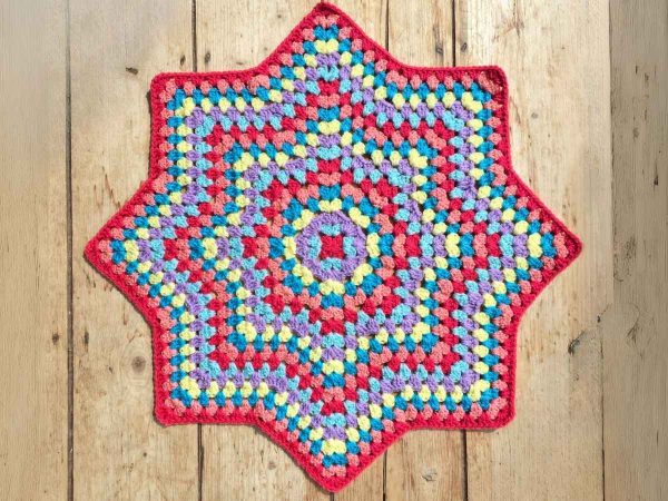 Finished crochet Granny Star on a wooden background
