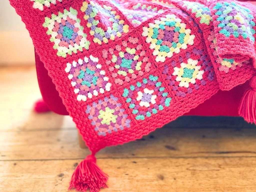 Close up of the granny squares blanket and the tassels added to the corners