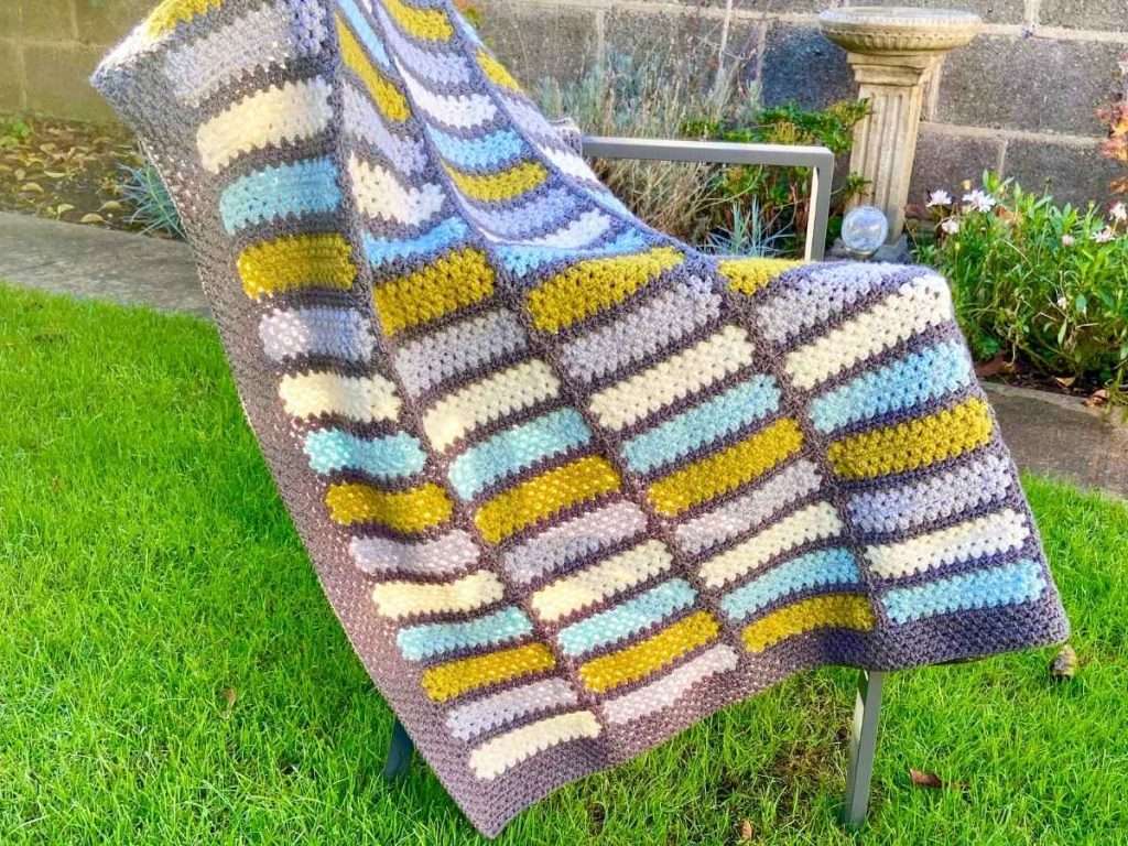 Finished modern crochet rectangle blanket made with grey, white, green and blue