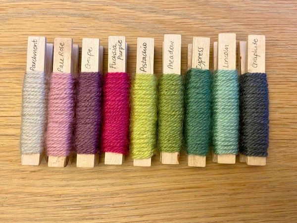 Yarn pegs in a row for the Rainforest Patchwork Squares Blanket