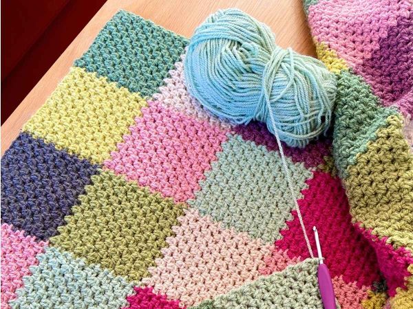 Rainforest blanket laid flat showing full patchwork design in progress