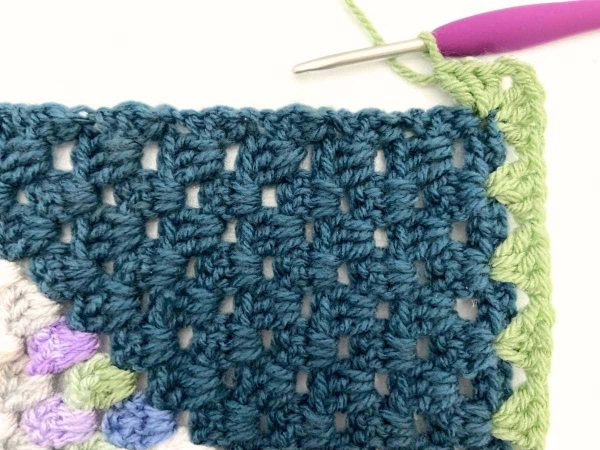 Photo showing how the corner is worked on a crochet blanket