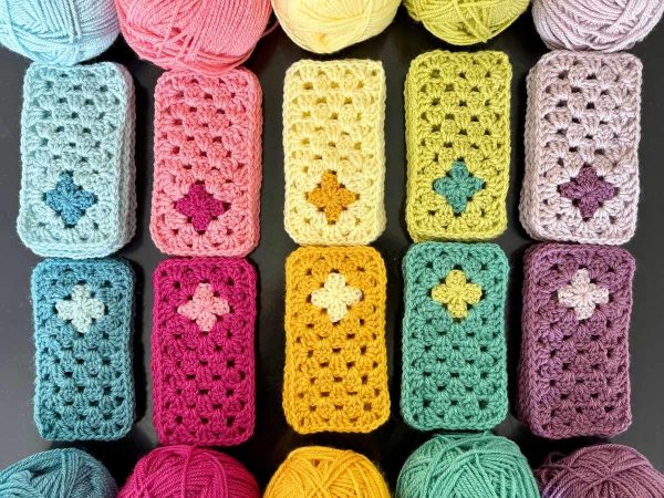 colourful crochet rectangles laid on a black surface